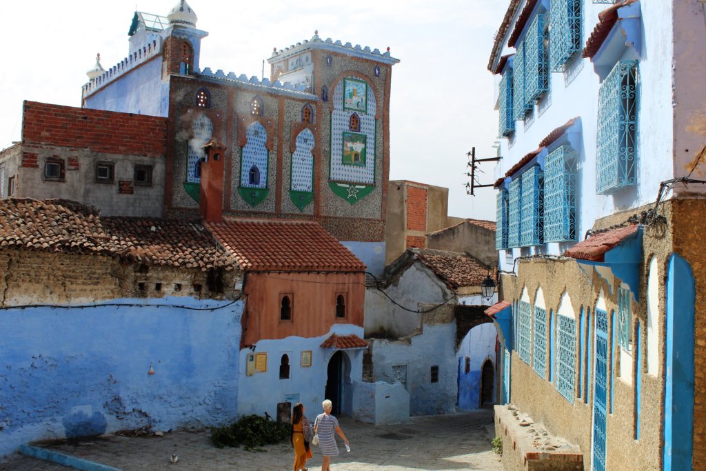 This photo shows a street in the medina with blue-painted houses