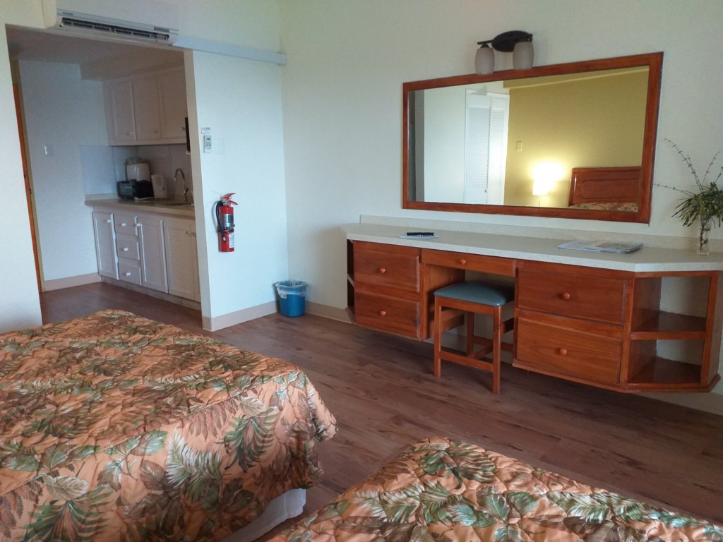 This photo shows our room at the Crown Point Beach Hotel with its two beds, large dressing table and mirror and well-equipped kitchen.