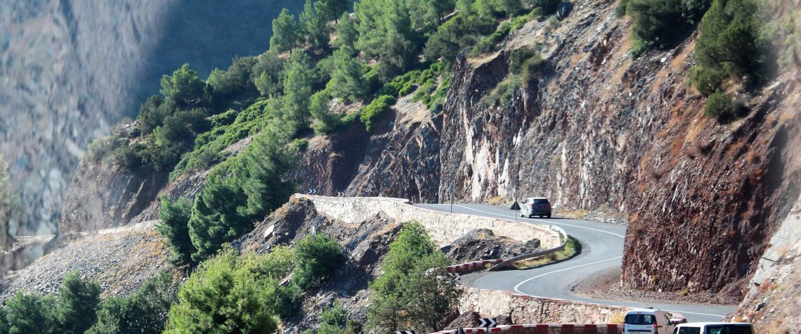 This photo shows a very windy road clinging to the side of a mountain
