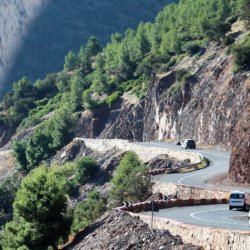 This photo shows a very windy road clinging to the side of a mountain