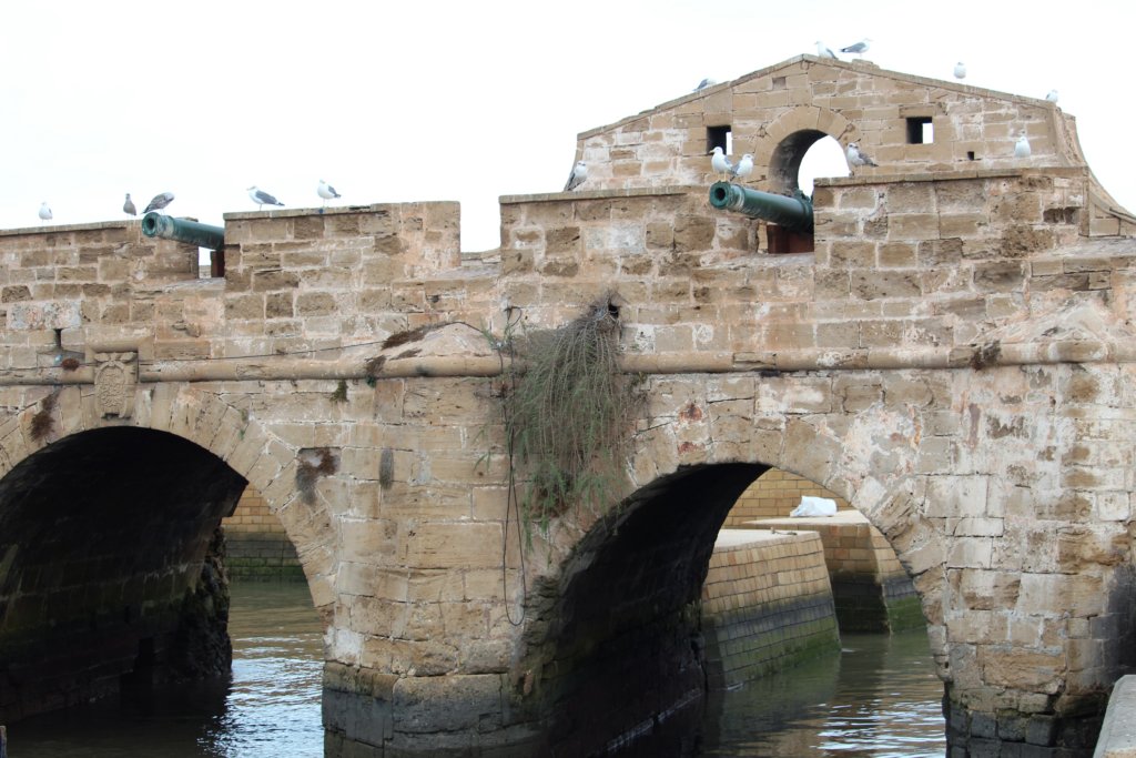 This photo shows the ramparts with water running through the archway underneath