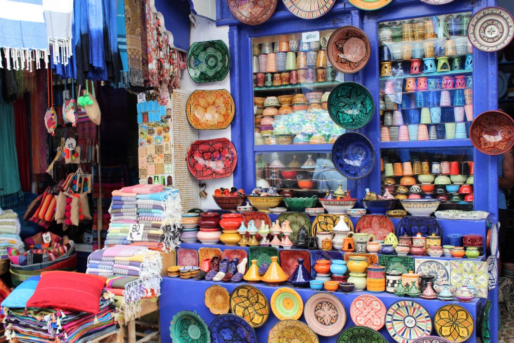 This photo shows a colourful display of pottery outside a shop