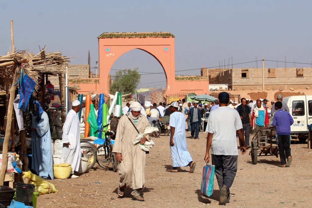 This photo shows shoppers going about their business in the market. 95% of them are men.