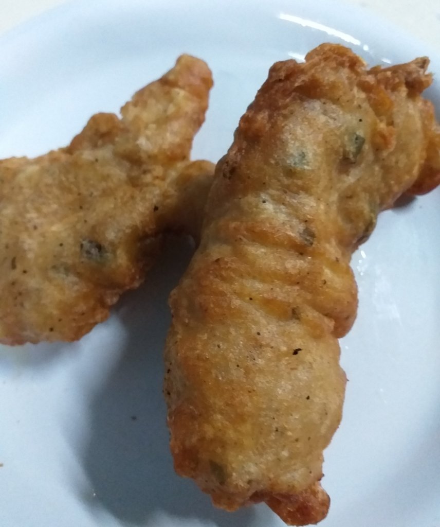 This photo shows two pieces of lionfish fried in beer batter on a plate