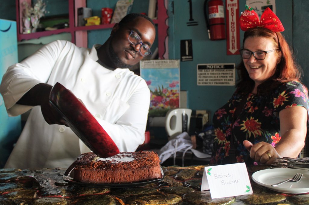 This photo shows the chef flambeeing the black cake on Christmas Day