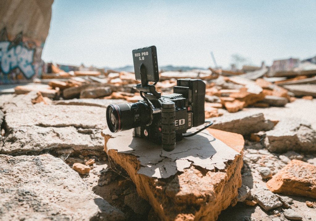 This photo shows a video camera sitting on some rocks.