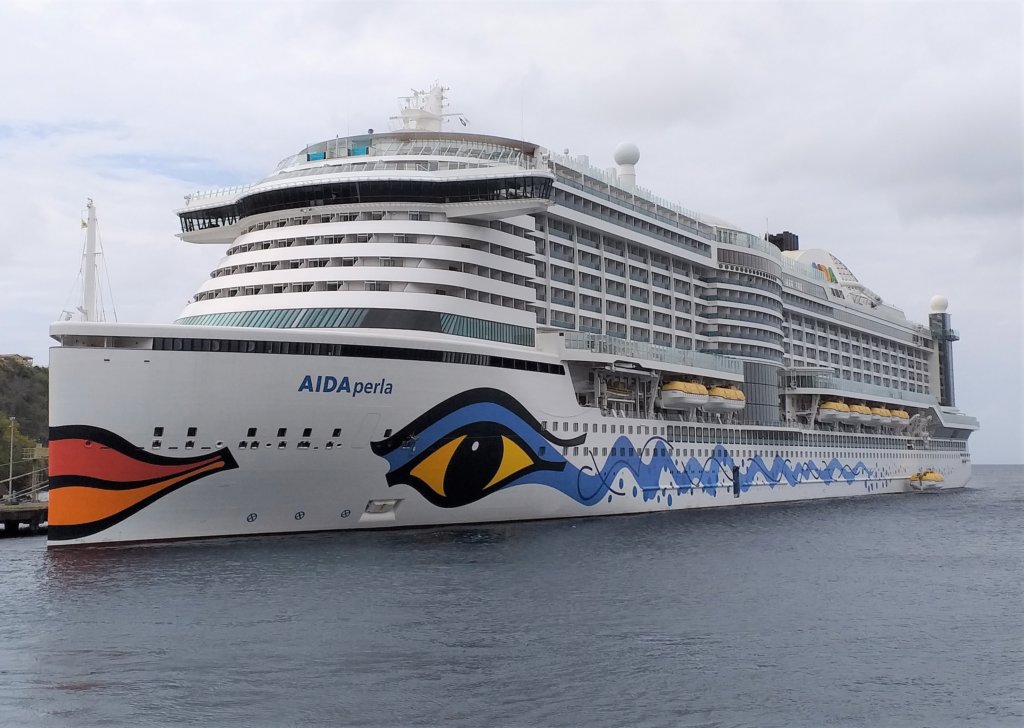 This photoshows an enormous cruise ship with eyes and a mouth painted on the bow.