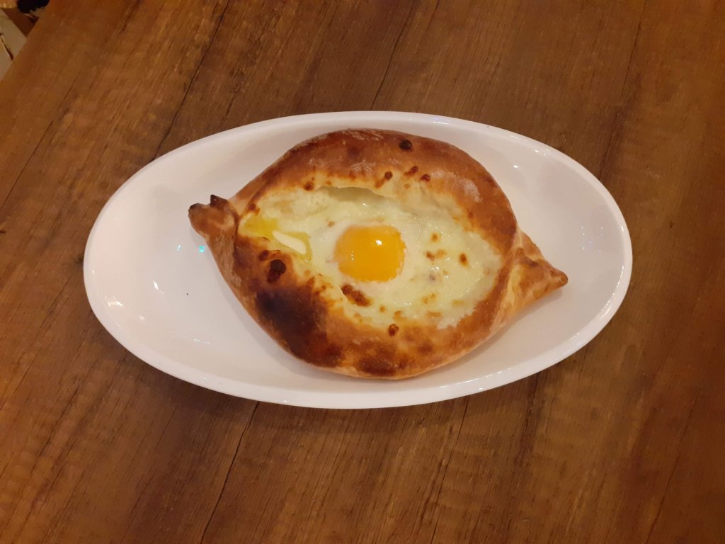 This photo shows chhese filled bread topped with a fried egg