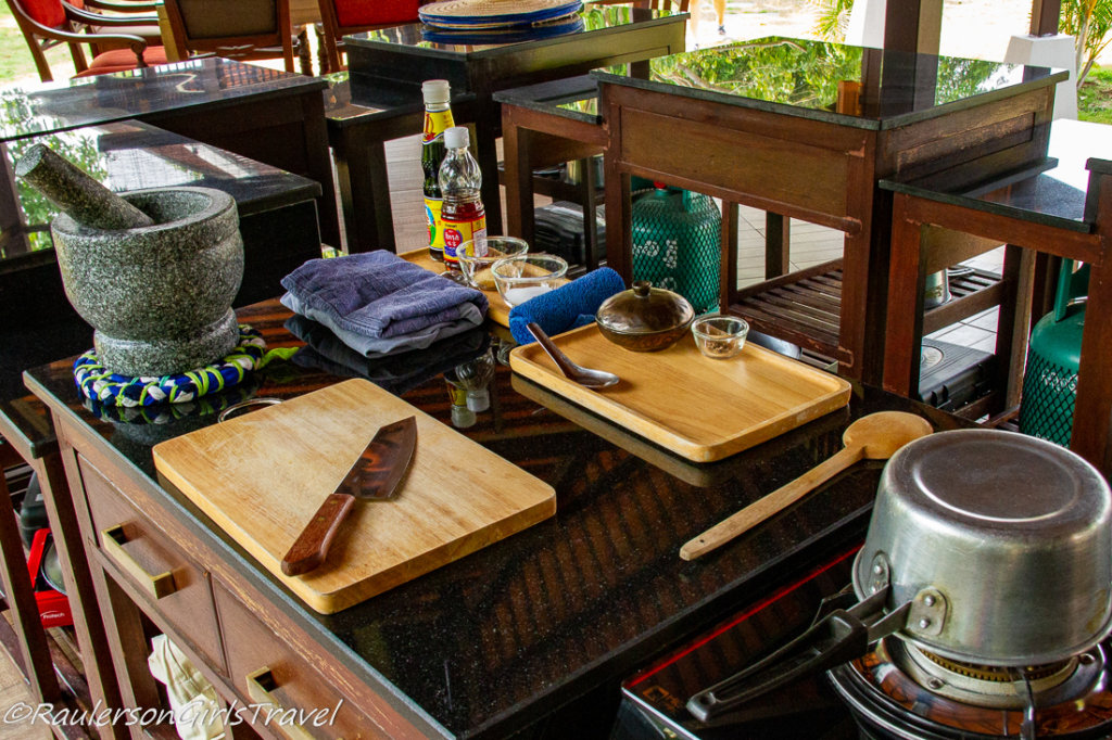 This photo shows a table with chopping boards and knives ready to cook