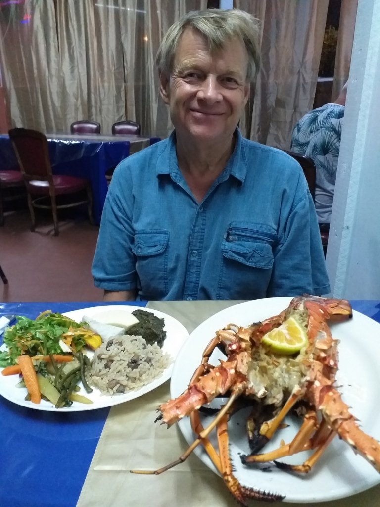 This photo shows Mark with a huge lobster and accompanying vegetable plate
