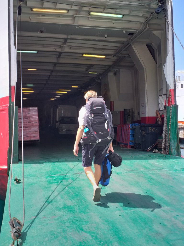 This photo shows Mark walking on to the ferry carrying his backpack