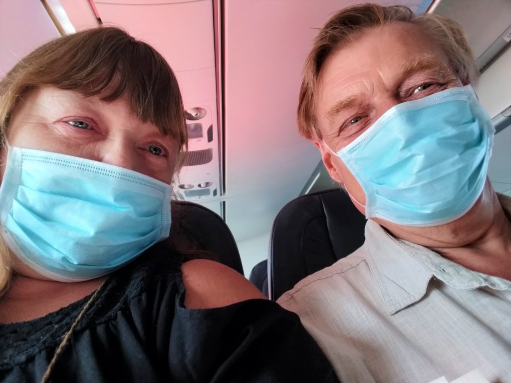 This photo shows Mark and I on the plane wearing our masks and feeling very weary