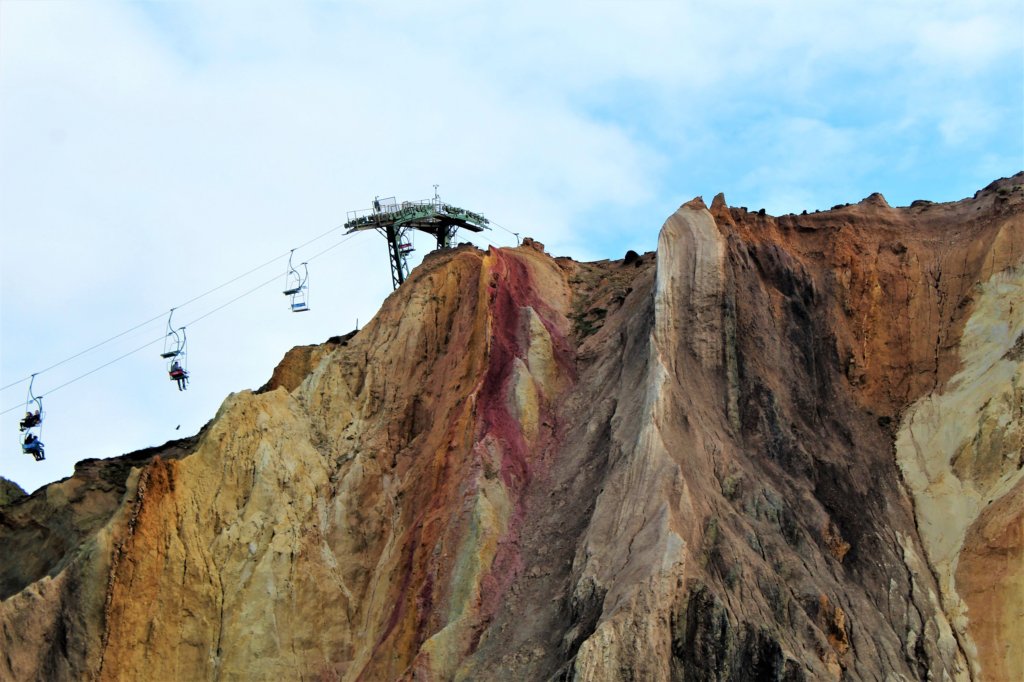 This photo shows several gondolas on the chairlift