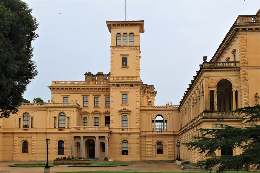 This photo shows the front of Osborne House built in yellow sandstone with an imposing square tower