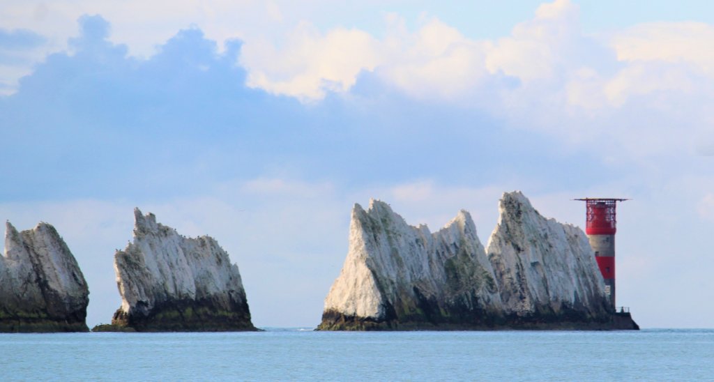 This image shows the three chalk stacks and the red and white lighthouse