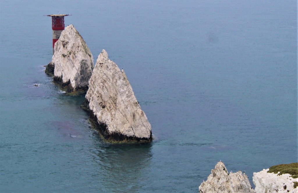 This image shows the chalk stacks of the Needles and the lighthouse