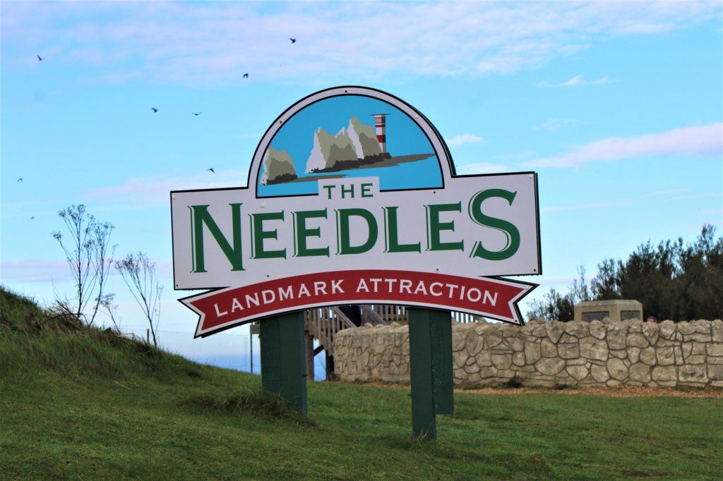 This photo shows a sign announcing that you have arrived at the Needles Landmark Attraction