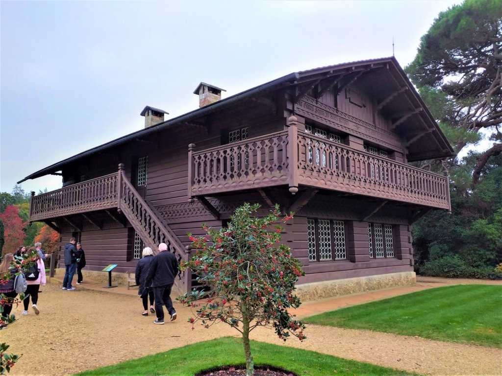 This photo shows Swiss Cottage from the outside - a Swiss-style wooden chalet with an outside stair case