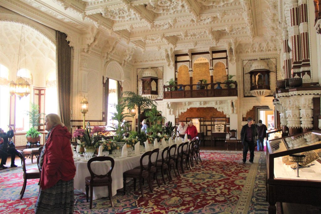 This photo shows the Durbar Room with a huge dining table laid for an exquisite banquet