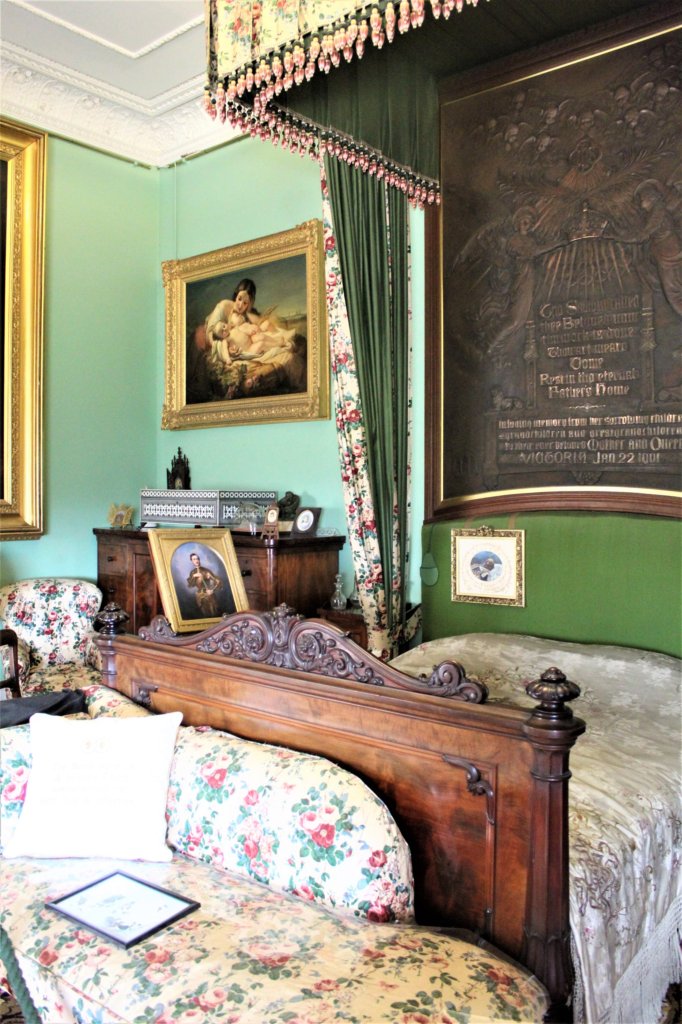 This photo shows a short bed with heavy drapes 