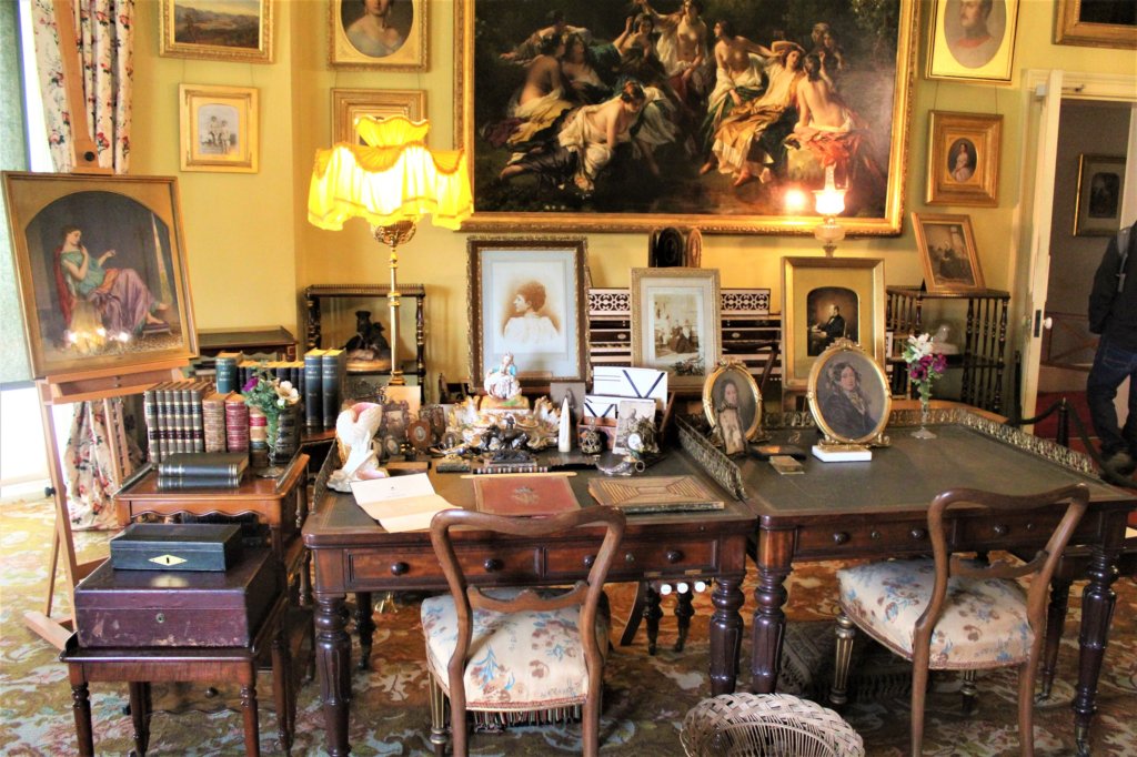 This photo shows the royal study with family photos on the matching his and hers desks