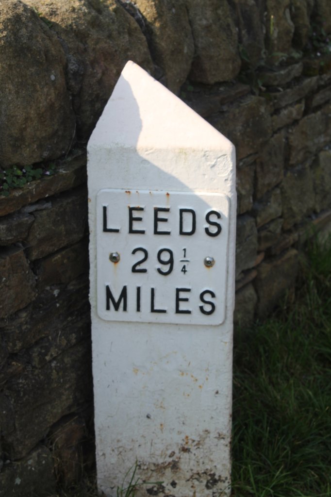 This photo shows a milemarker with Leeds 29 and a quarter miles on it