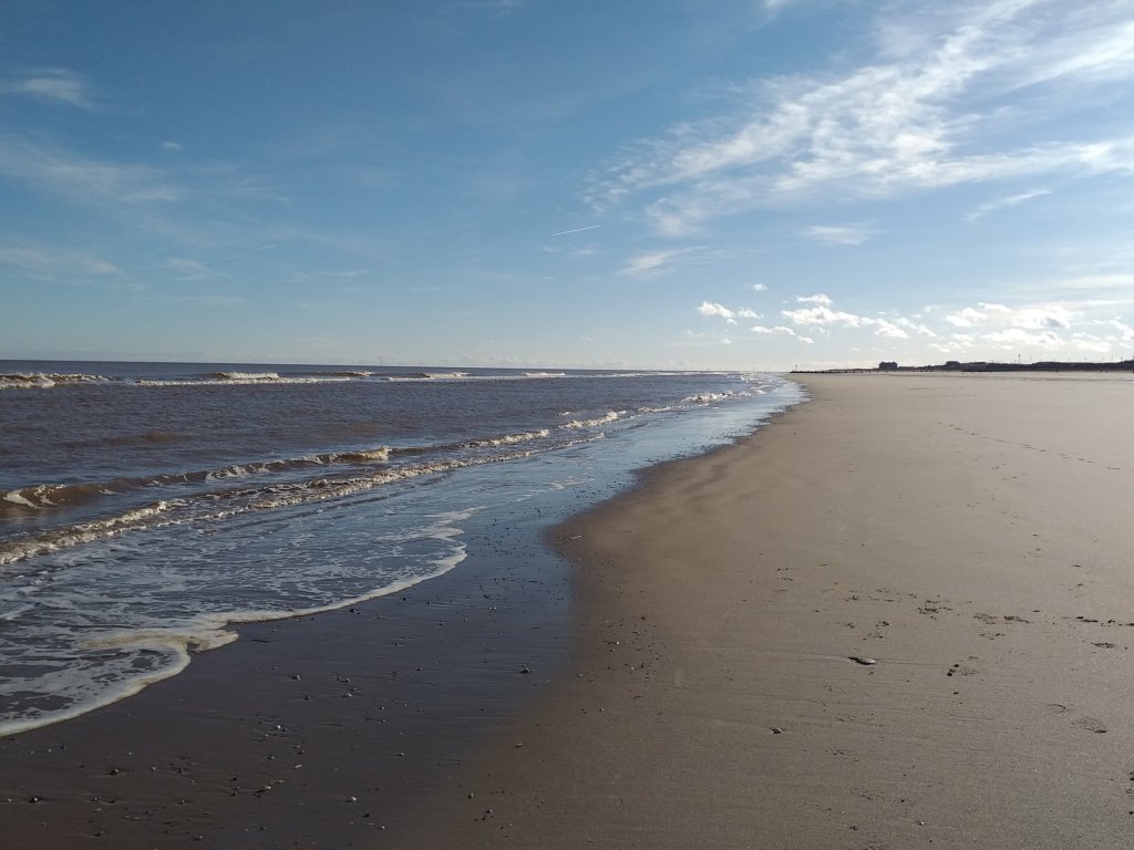 This photo shows the sun shining on a deserted beach