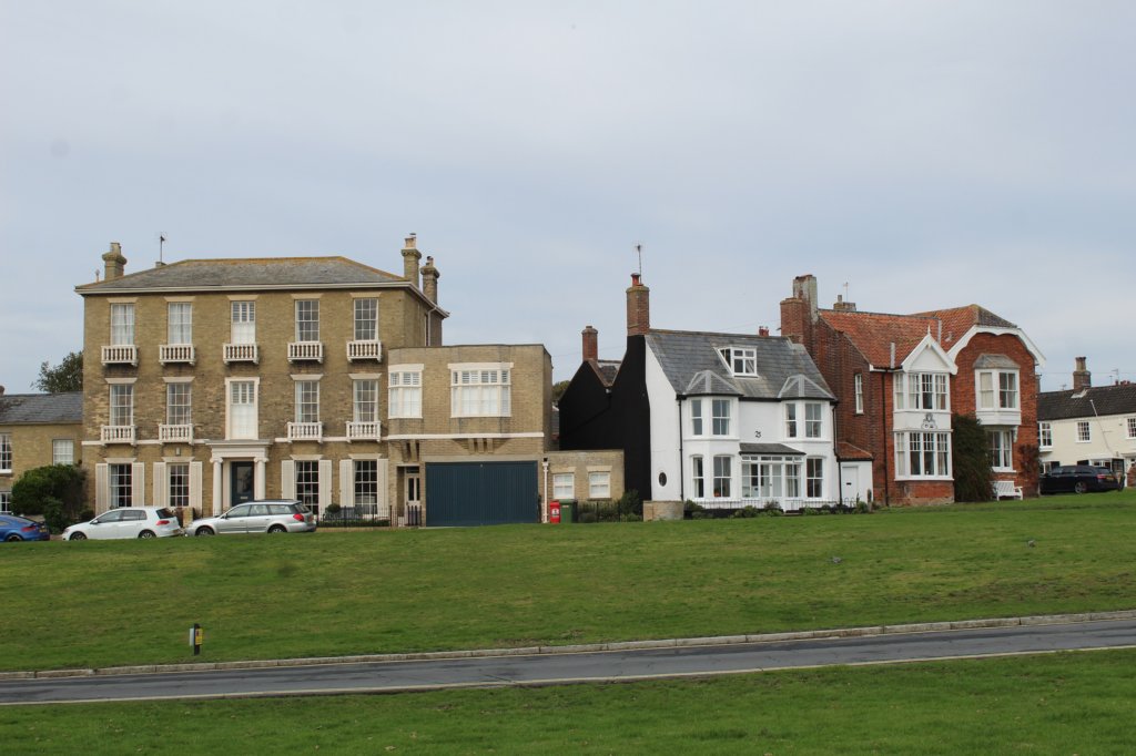 This photo shows some Georgian houses next to a green.