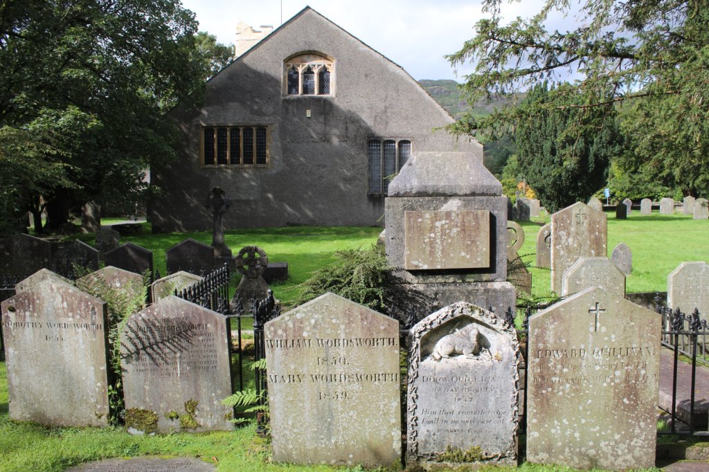 This photo shows a church with the graves of William Wordsworth, his wife, Mary, and his sister, Dorothy in the foreground