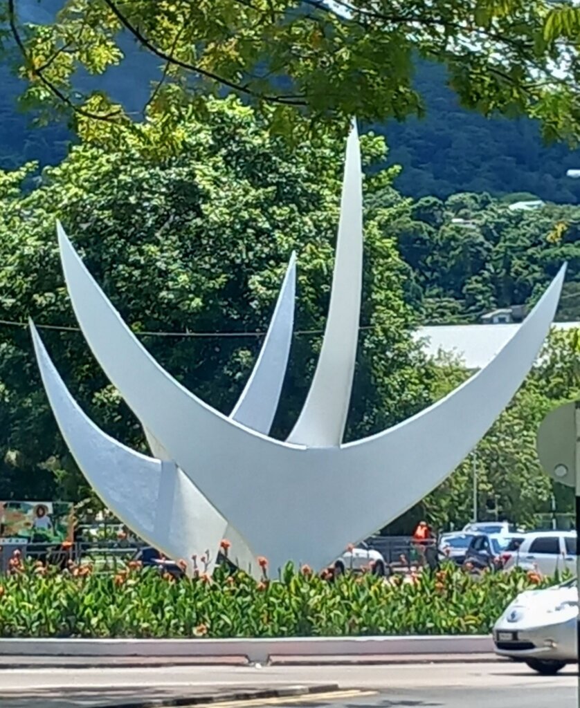 This photo shows the two large white boomerang-shaped structures that make up the Bicentennial Monument.