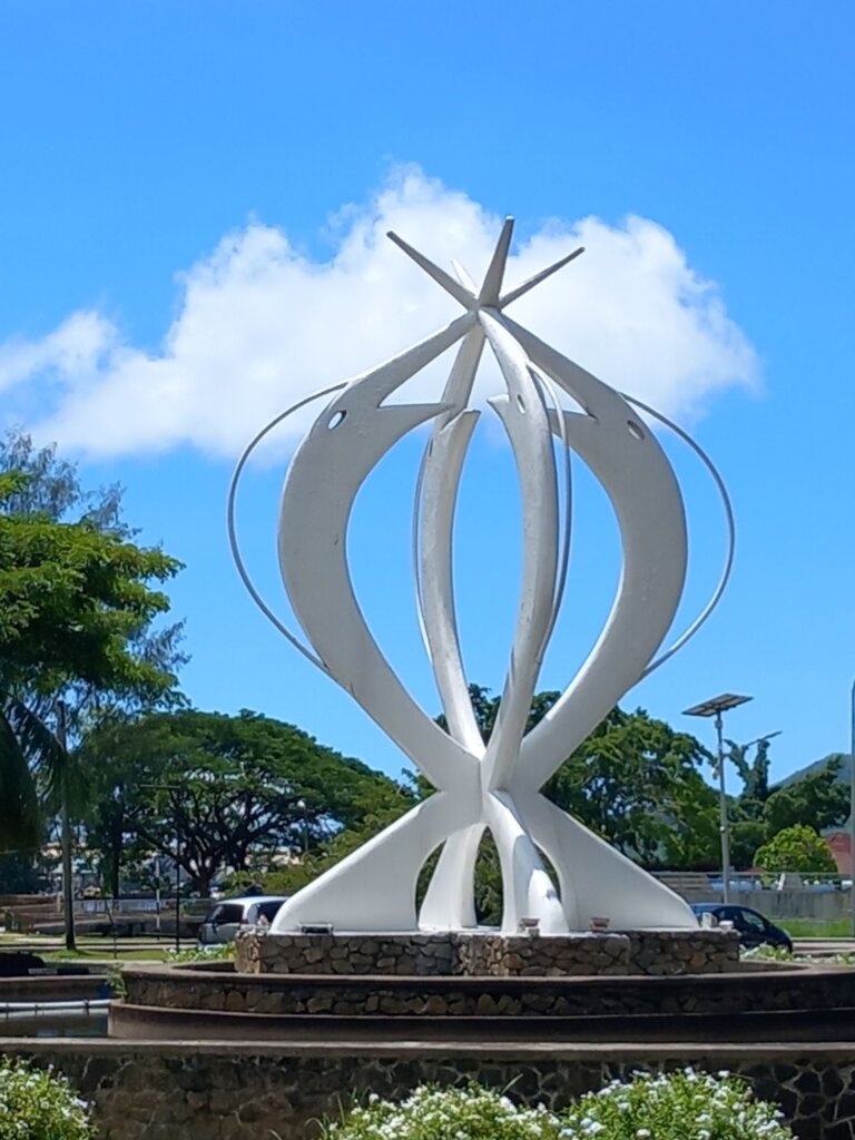 This photo shows the brilliant white Unity Monument with four giant fish meeting at their heads