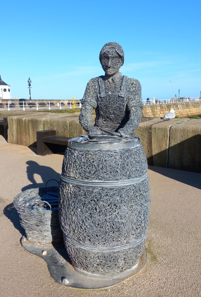 This image shows a sculpture of a herring girl