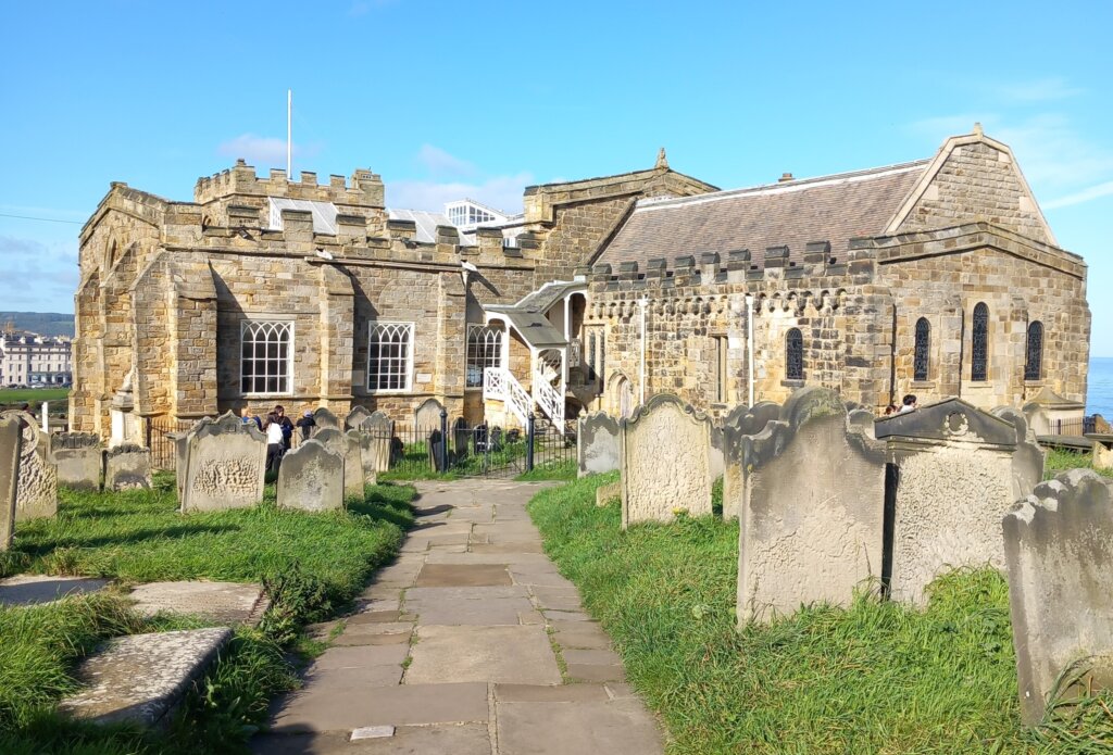 This photo shows the south side of the church with graves in the foreground