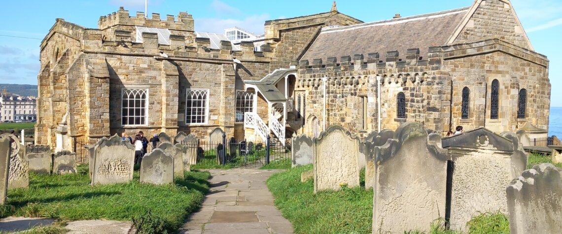 This photo shows the south side of the church with graves in the foreground