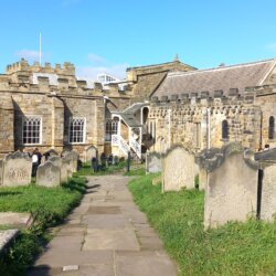 This photo shows the south side of the church with graves in the foreground