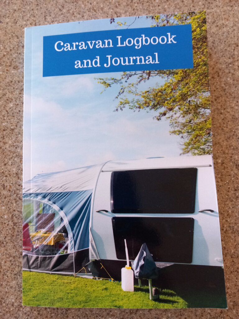 This photo shows the front cover of my caravan logbook.  It shows a caravan with an awning attached.