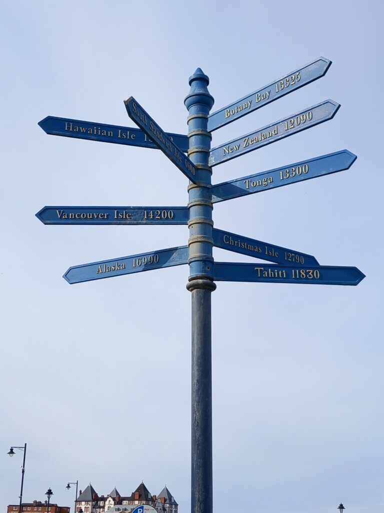 This photo shows a signpost with signs pointing to many of the places james Cook discovered