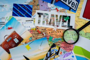 This photo shows a range of items linked to travel - a map, some postcards, a calendar, etc.